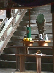 Offerings placed before the steps leading to the inner chamber of Kamosu Jinja